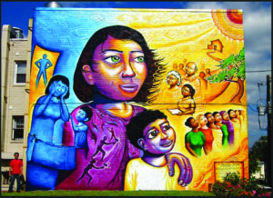 Joel Bergner’s A Survivor’s Journey: The Domestic Violence Awareness Mural depicts the journey of survivors of domestic abuse, leaving behind danger and pain, and looking with hope to the future.