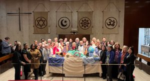 2024 CSW participants gathered around altar